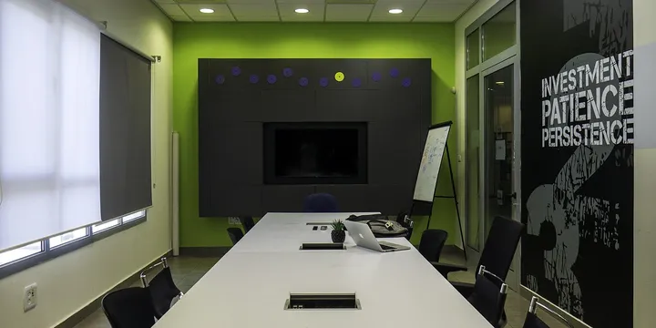 Empty meeting room with a long white table